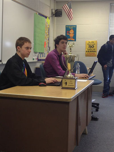 TITANS TAKE TREVIANS: Listening to judges explain their decisions in the final debate of the junior varsity State debate tournament, sophomore partners Brian Roche (left) and Michael Callahan (right) take notes to improve for future debates. Roche and Callahan defeated a partnership from new Trier to win the championship. 