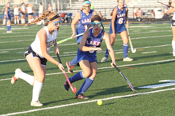 GOGGLE GAL: Running around a Lake Forest defender, junior defender Megan Dillon looks to pass to a teammate. At the end of the game the score was tied 2-2 and the Titans lost in overtime to the reigning state champions 3-2. 
