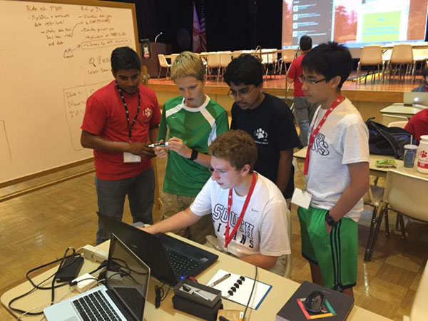 BRO CODE: Collaborating in website creation, freshmen Nicholas Ermolov, Ahmed Malik, Jesus Crespo and Matt Moran (seated) receive instruction from a coding expert. The boys coded for a full 24 hours and learned valuable skills along the way.  Photo courtesy of Mike Sinde