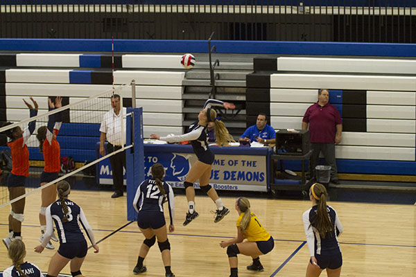 KLAPACZ KILLS: Jumping in the air, senior captain Cory Klapacz spikes the ball over the net. The Titans beat Evanston with a score of 25-17 and 25-20 on Oct. 27. GBS played Evanston five times this season, beating them four times and losing once.