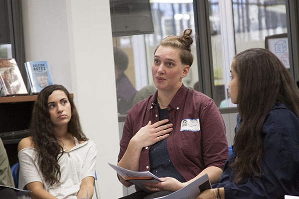 SOCIAL TRANS-FORMATION: During a discussion in the library, sophomore Emily Joseph listens intently to the speaker, AJ Jennings, who came to GBS on Nov. 19 to discuss transgender awareness in the community.