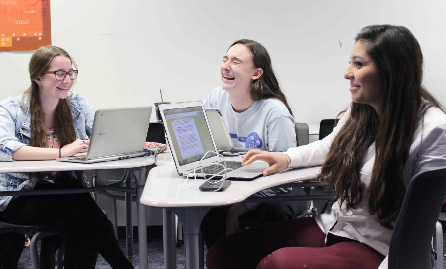 TESTING CHANGES: As part of the new furniture pilot at South, seniors
(left to right) Grace DuBois, Grace Pulos and Diana Perez participate in their classroom activity at desks that double as whiteboards.