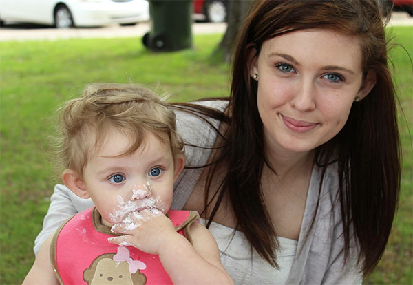 CAKE, PLEASE: Celebrating Aubree’s first birthday in May of 2013, Kelly Schaeffer, mother and former South student, and her daughter eat cake with friends and family in a local Kentucky park. Since Aubree was born, Schaeffer has continued on to work towards a college degree but urges teens to abstain from sex because of the challenges derived from juggling high school and a child. 