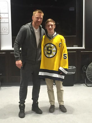 HOSS THE BOSS: posing  next to three time Stanley Cup champion Marian Hossa, Matt Grinde smiles for a picture. photo courtesy of Matt Grinde