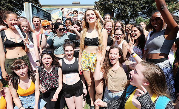STANDING IN SOLIDARITY: Wearing crop tops in defiance, students at the Etobicoke School of the Arts in Toronto protest their school’s “sexist” dress code in May of 2015. This particular instance is just one of many, as an increasing number of schools begin a debate over the controversy surrounding dress code policies. 
