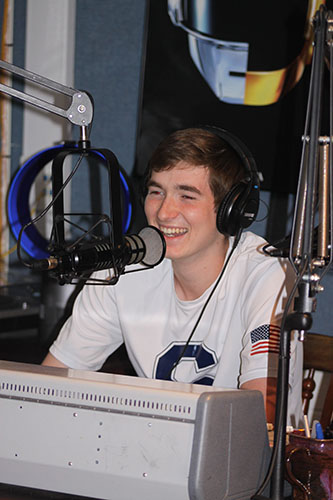 BROADCASTING BLISS: Speaking into the microphone, senior Matthew Peterson broadcasts at South’s WGBK Radio. Peterson is one of many students at South that found their passion through their elective courses.