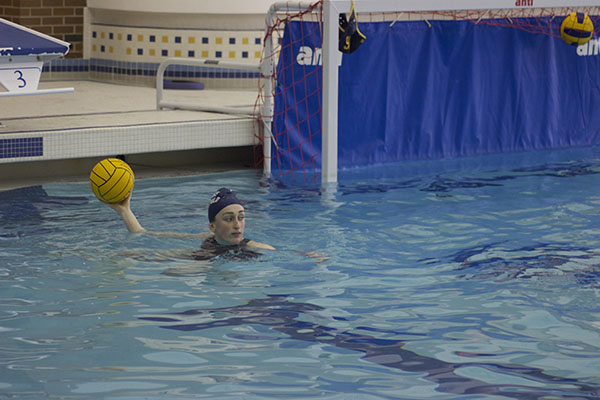 HANDS UP: Looking to pass the ball to a teammate, junior Kelly Klish treads water during a scrimmage at practice. 