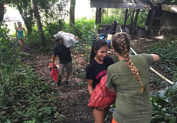 Twenty-Four Carrots:   Working with a fellow trip participant, sophomore Emma Noffke hands off a bag of carrots to feed the animals she cares for on her trip.  This summer she traveled to Guatemala through the organization The Road Less Traveled.  Photo courtesy of Emma Noffke