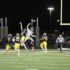 Friday night lights: Attempting to intercept the ball, junior Andy Sirakides (#8) jumps along side a St. Patricks runningback on Sept. 10. The Titans lost to St. Patricks by a score of 21-7.