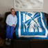 GRINS AND GIFTS: Appreciating her new present, science teacher Linda Kocian poses with a quilt given to her by fellow colleague Suzanne Webb as a “get well” gift. Kocian received lots of support from South’s staff when she was diagnosed with Multiple Myeloma. Photo courtesy of Jennifer Friedmann