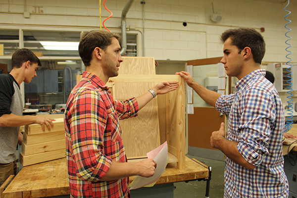 Supervising Silca: Woodworking teacher Stephen Silca provides insight on senior Jeffrey Mitchells woods project. Silca has been teaching woodworking at South for five years.