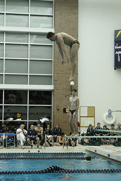 ACH IN THE AIR: Practicing before a dual meet during his senior year at GBS, Aaron Ach, current Princeton sophomore completes a pike dive. Ach now dives at Princeton.
