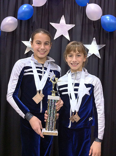 Smiley sisters: Posing with their trophy, sisters Hannah (age 11) and Jenna (age 9) Hartley, celebrate their second place finish in the all-around event at the Make a Wish Classic in 2011.