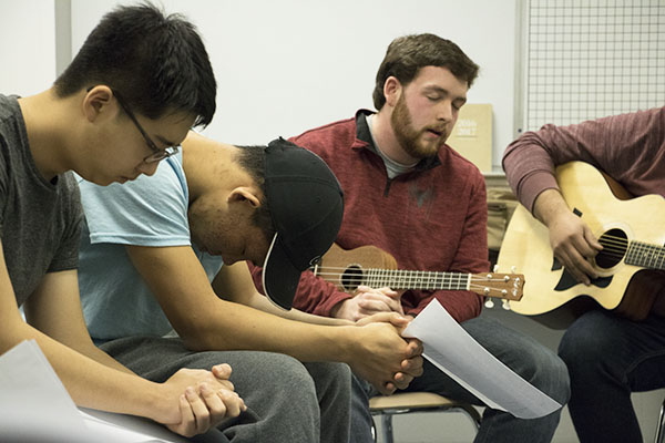 Powerful   Praise: With heads bowed in thoughtful prayer, members of the Cornerstone Christian Club, formerly known as H2O, sing and recite verses at their weekly meetings. Club president John Park believes that school-provided prayer rooms are an important part in ensuring all students feel comfortable practicing their faith at South. 