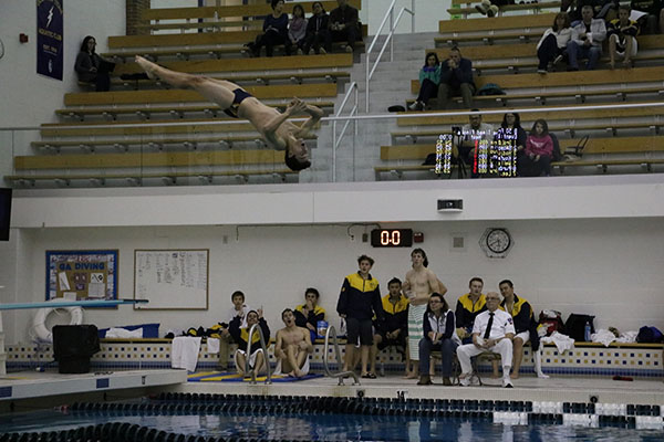 Breaking the water, senior Brendan Fontillas completes a twister.