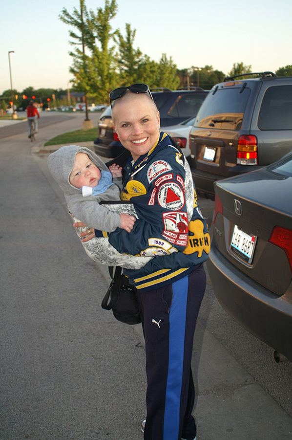 AWARD WINNIN’ GRIN:   Holding her son, the late Paula Hess, former Titan Poms choreographer, sports her letterman jacket, decorated with patches from previous competitions she participated in. Photo courtesy of Julie Smith