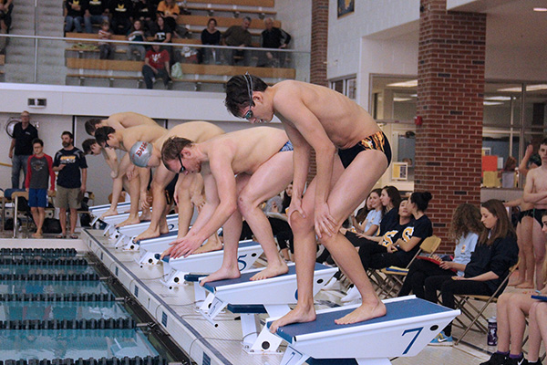 STARTING SHECHTMAN:  Preparing to take his mark, junior Nick Shechtman (foreground) listens for the offical to start the event at Titan Relays on Jan. 14. GBS came in first out of eight teams at Titan Relays, an invite South hosts every year where some non-traditional events, such as the 200 yard breaststroke relay, are included.