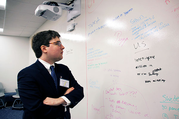 Diligent   Delegate:   Examining the notes compiled by the GBS Model UN team, Alex Economou, Model UN publicity chair, tries to plan the day’s different crisis committees and simulations. Economou has been a part of the GBS Model UN team since he was a freshman, and his involvement and resulting enthusiasm have brought him unique opportunities including writing for a Model UN blog and a spot on the All American Model UN team. 
Photo by Sophie Mason  