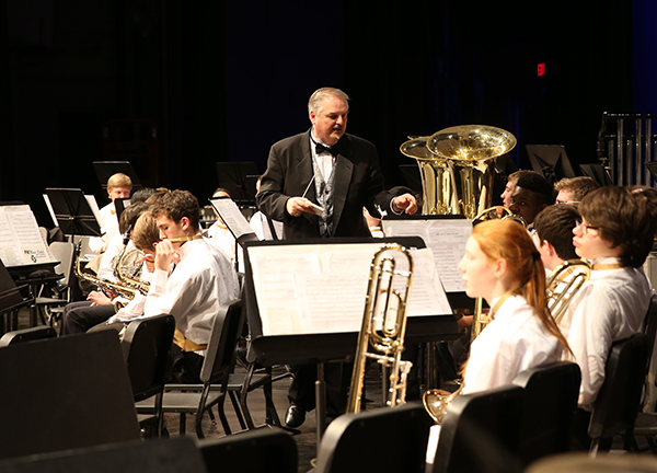 Graduating Greg:  Leading South’s band members, Greg Wojcik, head band director, prepares to conduct his final concert at South. Wojcik has been a member of the Titan family for 38 years and is retiring this year. 