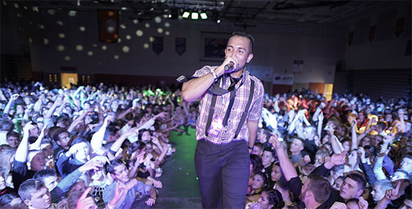 BOOMING WITH ENERGY: Riling up the students at Minooka High School, an MC walks down the catwalk at a dance facilitated by BOOM Entertainment. South also recently hired BOOM Entertainment to aid them in organizing the upcoming Homecoming dance, themed Windy City South.