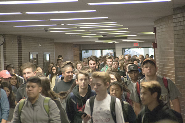 CROWDED CORRIDORS: Walking down the busy hallway as the bell rings at 3:15, South students make their way through the mob. South’s student population has been increasing over the last few years and the district has been making accommodations for this increase.