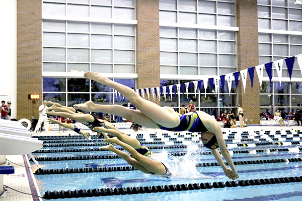 DIVING ME CRAZY:  Beginning her event, junior Leza Bergin competes against Niles West on Oct. 27. The Titans defeated the Wolves 94-92 and celebrated the class of 2018 at their senior night.  