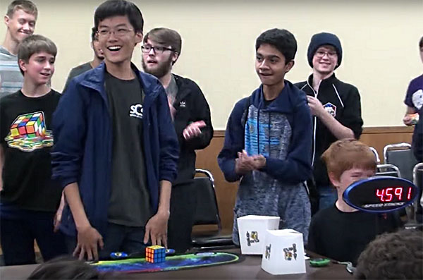 SPEEDY STEVE: Standing up in amazement, senior Steve Cho smiles as he realizes he solved the 3x3 Rubik’s Cube solve in 4.59 seconds at the ‘ChicaGhosts 2017” on Oct. 28. Cho has been cubing since 2012, and over the course of five years he has attended thirteen American Cube Association competitions. Photo courtesy of Steve Cho