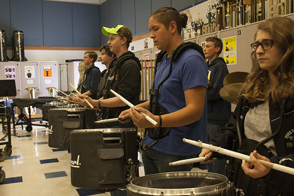 DEDICATED DRUMMERS: Members of South’s drumline, junior Bryce Brennan, senior Michael Vilches and senior Grace Rodriguez (from left to right) diligently practice in the band room after school. The drumline is a close-knit group composed of 17 members, according to senior drum captain Michael Vilches.
