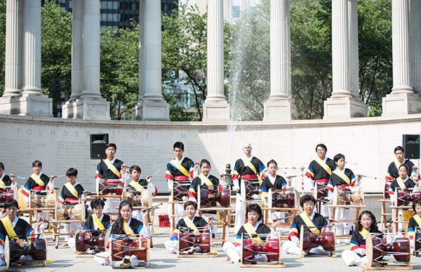 BANGING BUKS:   Celebrating the Korean New Year, junior Eddy Ji, back row, second from the right, stands alongside musicians from a traditional music group called Soribeat. Ji, who plays the buk and the janggu, two traditional Korean drums, tributes his increased closeness to his family and culture to his involvement in these instruments. 