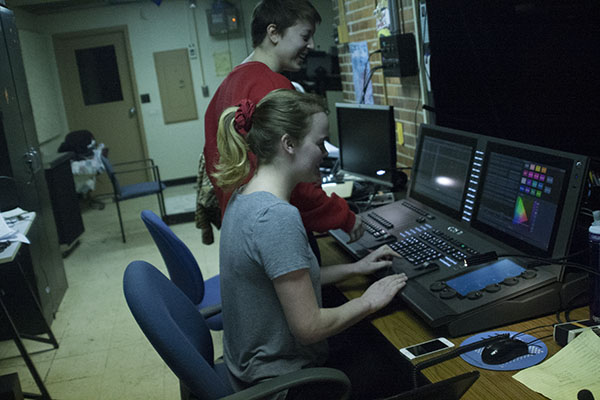 STUPENDOUS STAGE CREW:  Stage Crew members, juniors Emma Isaacs and Dru Tibbetts, work together on the sound board to change the lighting of the stage. Stage Crew creates unique sets for each production they work on.