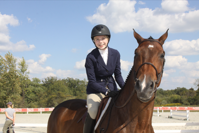 Smiling for a photo with her horse, sophomore Caroline Sultz prepares for a show. According to Sultz, riding is very a competitive sport and deserves more recognition. Photo courtesy of Caroline Sultz.
