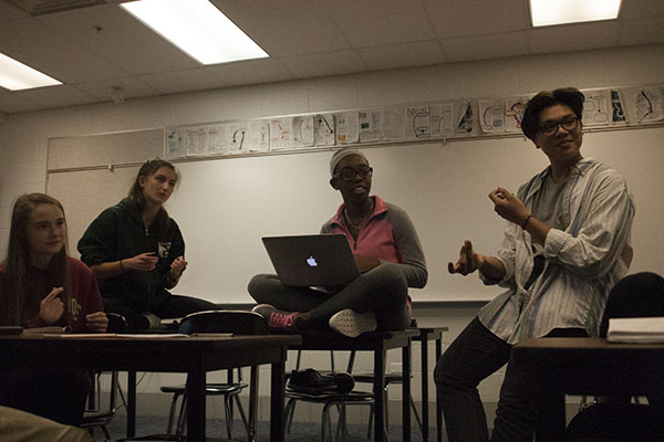 SUPPORTIVE SNAPPING:  Listening to his peers’ poems, freshman Justin Manalang snaps, signifying agreement and relatability. Poets at South gather in preparation for Louder than a Bomb, a youth poetry festival, which takes place on March 18. 