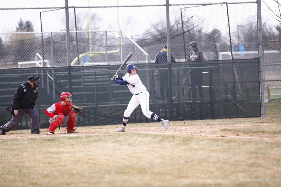HITTIN’ DINGERS:  Eyeing the pitch, senior Jacob Newman looks to connect with the ball against Deerfield. The Titans fell to the Warriors 15 to 4.