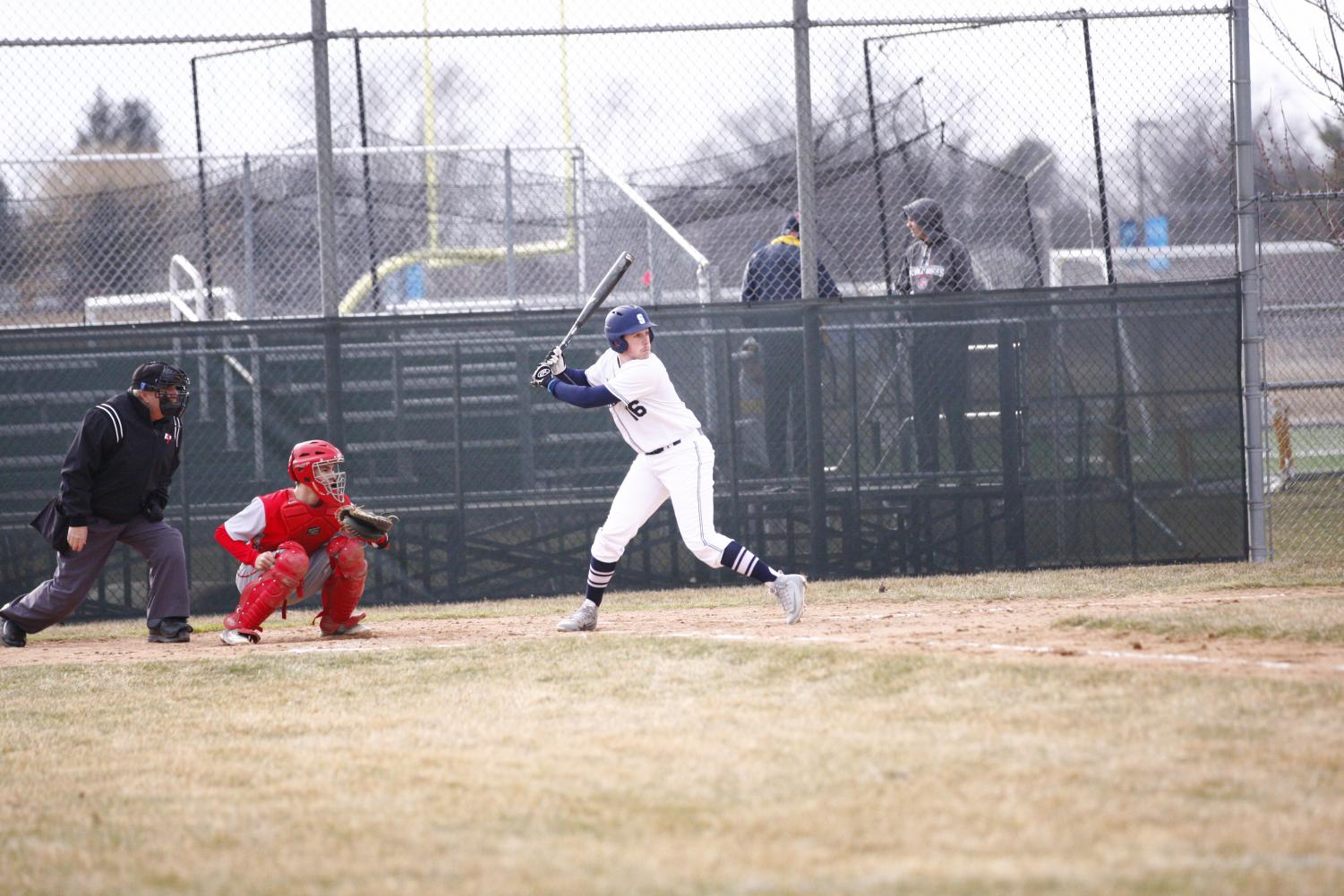 HITTIN’ DINGERS: Eyeing the pitch, senior Jacob Newman looks to connect with the ball against Deerfield. The Titans fell to the Warriors 15 to 4.
