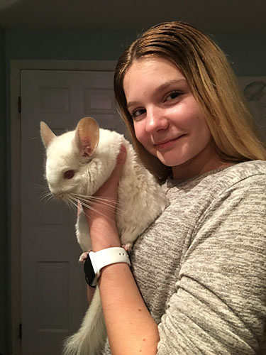 Furry Friends: Cuddling her pet, sophomore Emma Bird holds her albino chinchilla Faux for a picture. South students own a variety of exotic animals.
