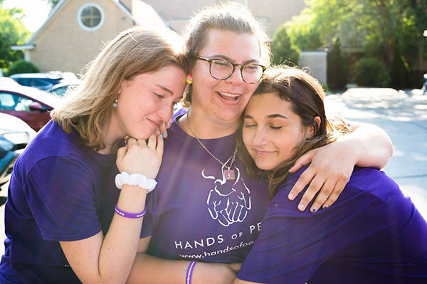 Emotional Experience: Hugging fellow American participants, senior Eliza Schloss cries after watching the Israeli and Palestinian participants depart at the end of the Hands of Peace program.  Schloss participated in this program in order to gain a new perspective regarding the Israel-Palestine conflict.