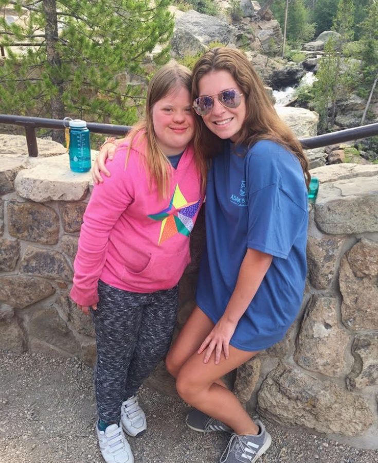 Mollys   mission:   Smiling with a camper, senior Molly Stryker (right) poses for a photo after a hike. Stryker spent a week at Adam’s Camp over the summer.