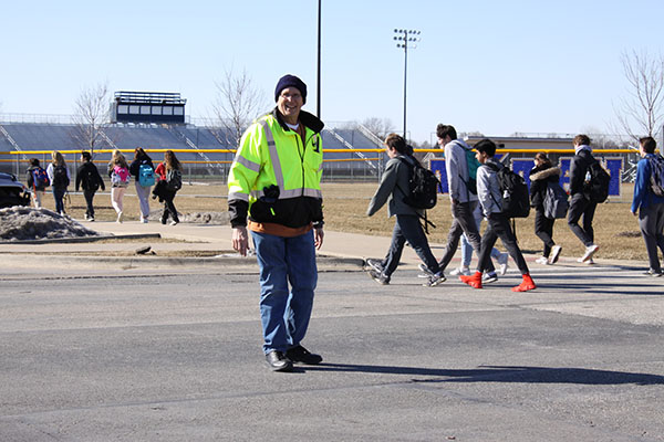 Braving the cold, Stankowicz directs school traffic. The West lot is full of students and cars after school, and Stankowicz works to keep students safe no matter the weather.