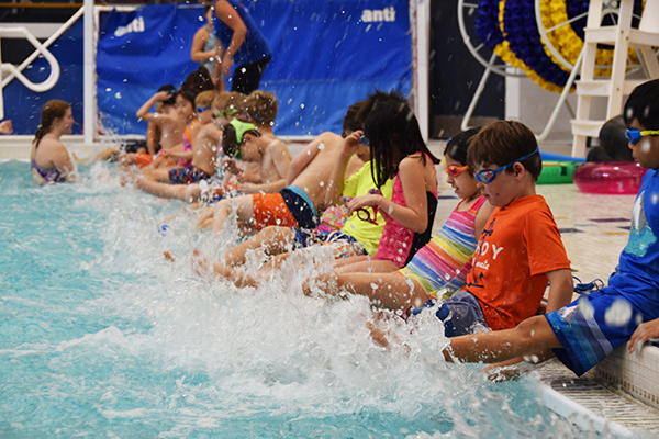 Splashing Swimmers: Practicing their kicking skills, kids in “Learn to Swim” are taught by South students. Founded in 1962, the program helps teach young children how to swim while building leadership skills in South students. 