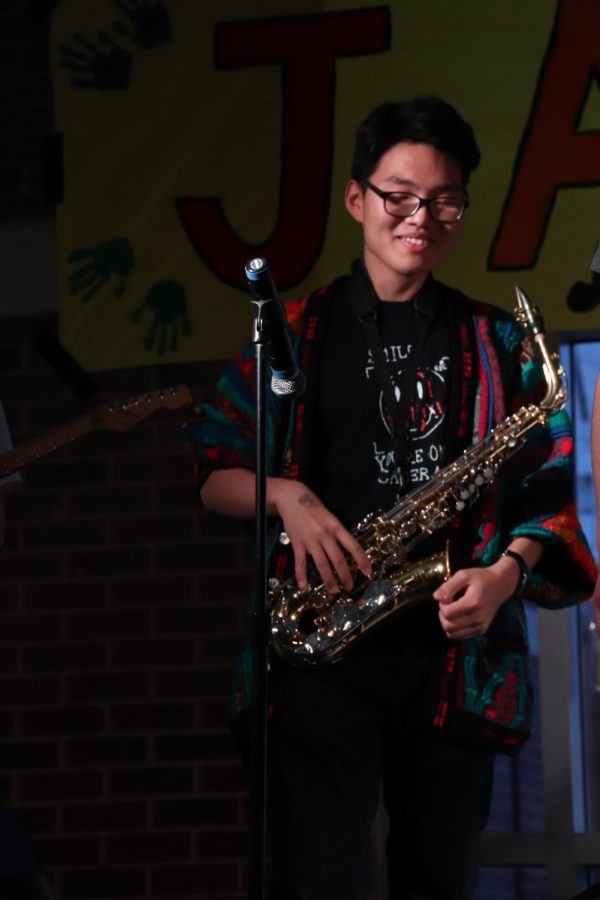 A NIGHT FOR HUMAN RIGHTS: Jamming on the stage, sophomore Yeon Park plays his saxophone at Jamnesty. This event took place on Friday, April 12 in the West Cafeteria and featured different acts as well as information speeches about human rights. 
