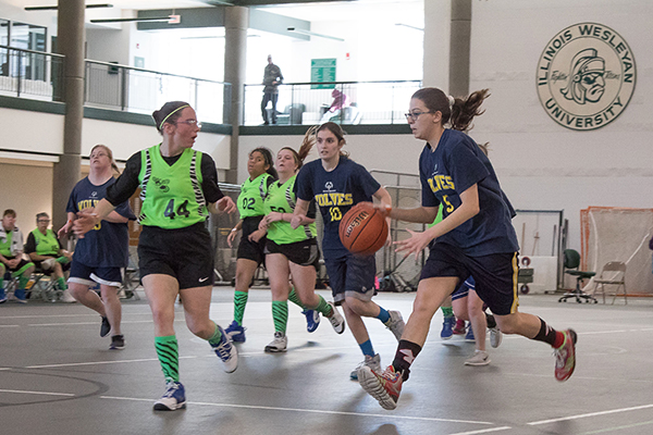 V-I-C-T-O-R-Y: Racing up the court, a member of the Glenbrook United basketball team, the Wolves, dribbles towards the basket. The Glenbrook United Special Olympics Team won four state titles in the four games they competed in on March 15-17. Photo courtesy of Christian Lantry