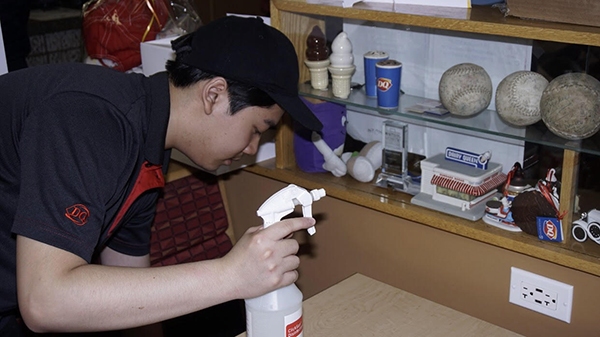  Taking a break from his regular duties behind the counter at Dairy Queen, sophomore Marcel Hoang cleans a table. Hoang started working at Dairy Queen in April. 