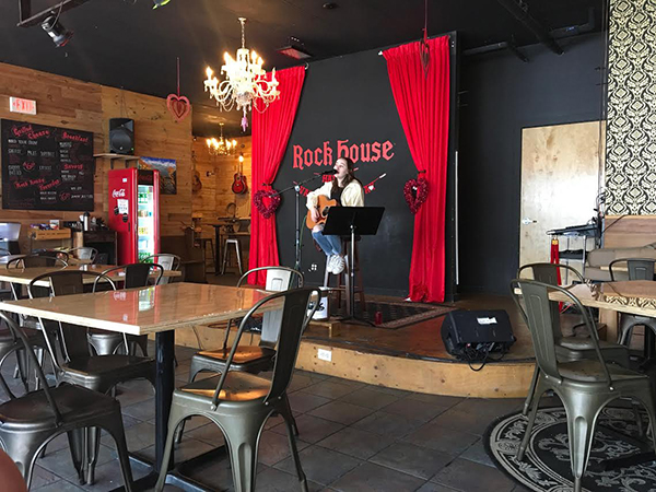 Playing the guitar and singing, junior Emily Patt performs at Rock House before announcing their closure of the cafe and stage in April of 2018. Rock House intends to shut down of the cafe to further develop their music school.