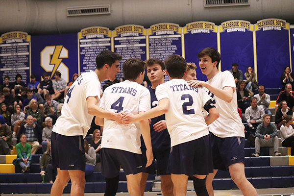 Spectacular Spiking:   Congratulating his fellow teammates on another winning point against their competitor New Trier, sophomore Kyle Busiel (far right) can be seen smiling with enthusiasm. Unfortunately, the boys’ volleyball team wasn’t able to win against New Trier on Senior Night ending with a score of 25-18 in the first set and 28-26 in the second.