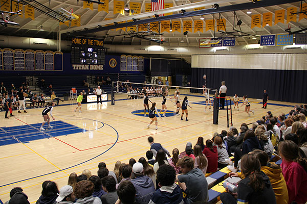 Showing Spirit: Putting up posters throughout the Glenbrook South building, Titan Nation rallied students together and came out to watch the varsity girls volleyball team face off against Glenbrook North on Oct. 31. As the student body cheered the team on, South was able to pull off a win with a final score of 2-0. 