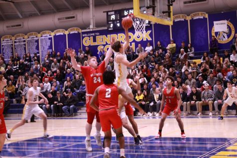 Bringing in Baskets: Jumping to the basket, senior Dominic Martinelli goes for the shot following senior Joe Shapiro’s injury on Dec. 13. South won 66 - 35 against Niles West. Photo by Nicole Surcel