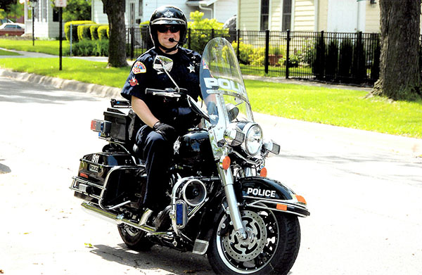 Crusin Cavender: Riding his motorcycle, Officer Cavender’s duties as a motorcycle cop include patrolling public events, like Fourth of July parades. Photo courtesy of Josh Cavender