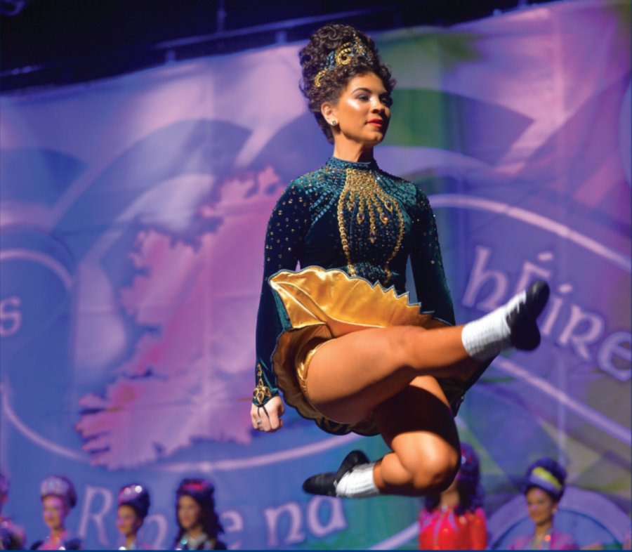 From then to now: Dancing through the years, senior Madaket Chiarieri leaps across the stage at her last competition ever. Chiarieri has Irish danced competitively since she was five years old.