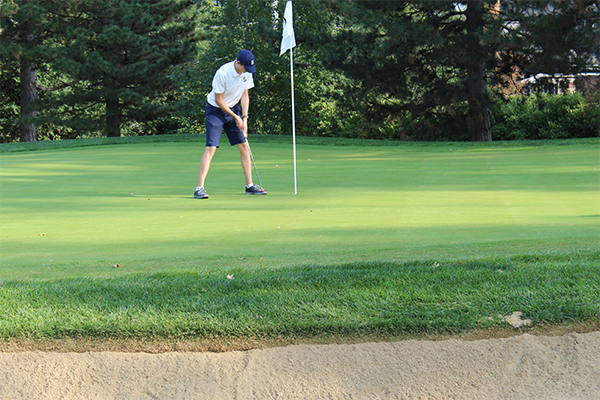 Putting Professional: Working on his putting game, senior Captain Sam Collett is trying to keep his team close despite the chaos of the season during a pandemic.