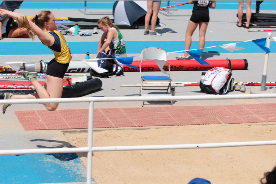 Soaring Sydney: Taking off on a long jump, senior Sydney Willits flies through the air, landing into the sand pit. With Willits’ family by her side, she plans to take her final track and field season at South in stride.